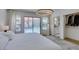 Bright main bedroom with white walls, a large rug, and sliding doors that lead to an outdoor swimming pool at 8640 Trafalgar Dr, Las Vegas, NV 89117