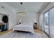 Bright main bedroom with white walls, a large rug, and sliding doors that lead to an outdoor swimming pool at 8640 Trafalgar Dr, Las Vegas, NV 89117
