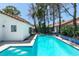 Backyard pool offers blue tile trim, a spacious patio, and mature trees for added privacy at 8640 Trafalgar Dr, Las Vegas, NV 89117