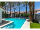 Inviting backyard pool with mature trees, tiled trim, and adjacent seating area, perfect for relaxation at 8640 Trafalgar Dr, Las Vegas, NV 89117