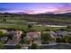 Stunning aerial view of estate home on golf course with lush landscaping at dusk at 9 Clear Crossing Trl, Henderson, NV 89052