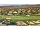 Aerial view of a golf course community showcasing lush greenery, ponds, and residential homes in a scenic setting at 9 Clear Crossing Trl, Henderson, NV 89052