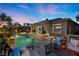 Relaxing backyard oasis with pool, spa, fire features, and comfortable seating under a colorful evening sky at 9 Clear Crossing Trl, Henderson, NV 89052