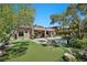 Spacious backyard with lush lawn, mature trees, pool, and putting green, perfect for outdoor enjoyment at 9 Clear Crossing Trl, Henderson, NV 89052