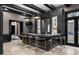 Elegant home bar featuring dark cabinetry, marble countertop, and seating for six with barstool chairs at 9 Clear Crossing Trl, Henderson, NV 89052