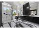 A sleek bathroom featuring black and white marble floors, stand up shower, and modern vanity at 9 Clear Crossing Trl, Henderson, NV 89052