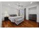 A cozy bedroom with hardwood floors, soft lighting, and a comfortable king-sized bed at 9 Clear Crossing Trl, Henderson, NV 89052