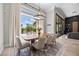 Bright dining area with a view of the pool and patio, featuring stylish furnishings and ample natural light at 9 Clear Crossing Trl, Henderson, NV 89052