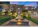 Elegant home with stone accents, manicured landscaping, and inviting entrance with illuminated walkway at 9 Clear Crossing Trl, Henderson, NV 89052