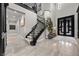 Elegant foyer with a curved staircase, soaring ceilings, modern chandelier, and marble flooring, creating a grand entrance at 9 Clear Crossing Trl, Henderson, NV 89052