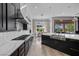 Modern kitchen boasts stainless steel appliances, a center island with sink, quartz countertops, and an open layout for entertaining at 9 Clear Crossing Trl, Henderson, NV 89052