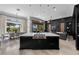 Open-concept kitchen featuring a large island, stainless steel appliances, modern lighting, and seamless flow to dining and living areas at 9 Clear Crossing Trl, Henderson, NV 89052