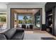 Living room features a seamless transition to the outdoor pool and seating area, offering an open and inviting space at 9 Clear Crossing Trl, Henderson, NV 89052