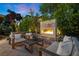 Cozy outdoor fireplace with comfortable seating, perfect for relaxation and entertaining in the backyard at 9 Clear Crossing Trl, Henderson, NV 89052