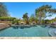 Refreshing pool with clear blue water, lush landscaping, and relaxing lounge area, ideal for summer days at 9 Clear Crossing Trl, Henderson, NV 89052