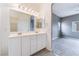 A bathroom with double sinks and view into the bedroom at 9303 Gilcrease Ave # 1013, Las Vegas, NV 89149