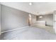Expansive living room featuring neutral paint, plush carpeting, and an arched doorway at 9303 Gilcrease Ave # 1013, Las Vegas, NV 89149