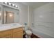 Bright bathroom with wood-look floors, white vanity, toilet, and a shower-tub combo at 950 Seven Hills Dr # 1921, Henderson, NV 89052