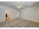 Bright bedroom featuring neutral carpet, white walls, and views into the laundry room at 950 Seven Hills Dr # 1921, Henderson, NV 89052