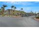 Gated community entrance offers security and privacy, enhanced by palm trees and landscaping at 950 Seven Hills Dr # 1921, Henderson, NV 89052