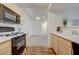 Bright kitchen featuring wood-look and carpet floors, light cabinets, white countertops, and black appliances at 950 Seven Hills Dr # 1921, Henderson, NV 89052
