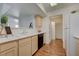 Bright kitchen featuring wood-look floors, light cabinets, white countertops, and black dishwasher at 950 Seven Hills Dr # 1921, Henderson, NV 89052