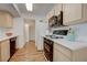 Bright kitchen featuring wood-look floors, light cabinets, white countertops, and black appliances at 950 Seven Hills Dr # 1921, Henderson, NV 89052