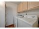 Bright laundry room featuring white washer and dryer, light cabinets, and white walls at 950 Seven Hills Dr # 1921, Henderson, NV 89052