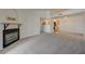 Bright living room features plush carpeting, a modern fireplace, and an open layout with a view into the kitchen at 950 Seven Hills Dr # 1921, Henderson, NV 89052