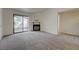 Cozy living room with plush carpeting, a fireplace, and a sliding glass door leading to a private balcony at 950 Seven Hills Dr # 1921, Henderson, NV 89052