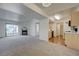 Spacious living room flows into the kitchen, featuring a fireplace, plush carpets, and access to the balcony at 950 Seven Hills Dr # 1921, Henderson, NV 89052