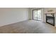 Inviting living room featuring a fireplace, plush carpeting, and a sliding glass door leading to a balcony at 950 Seven Hills Dr # 1921, Henderson, NV 89052