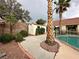 Backyard features a pool, shed, palms, and a brick wall fence at 1006 Winding Hill St, Henderson, NV 89002