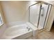 Bright bathroom featuring a soaking tub and a separate glass-enclosed shower at 1006 Winding Hill St, Henderson, NV 89002
