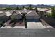 Aerial view of a single-story house with a three-car garage, desert landscaping, and a well-manicured lawn at 1006 Winding Hill St, Henderson, NV 89002