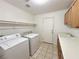 Well-equipped laundry room with a washer, dryer, storage, and sink at 1006 Winding Hill St, Henderson, NV 89002