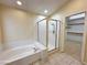 Bathroom featuring a shower, soaking tub, and doorway to the walk-in closet at 1006 Winding Hill St, Henderson, NV 89002