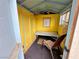 The shed interior features a simple bench, an image on the wall, and a chair at 1006 Winding Hill St, Henderson, NV 89002