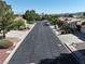 Street view in a well-maintained neighborhood with neat landscaping and mature trees under clear sky at 1006 Winding Hill St, Henderson, NV 89002