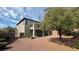 A spacious backyard featuring desert landscaping, a patio, and a second story balcony at 10066 Golden Bluff Ave, Las Vegas, NV 89148