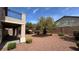 Landscaped backyard featuring decorative rock and shrubbery at 10066 Golden Bluff Ave, Las Vegas, NV 89148