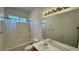 Well-lit bathroom with a shower-tub combination and a large mirror above the sink at 10066 Golden Bluff Ave, Las Vegas, NV 89148