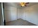 This bedroom has carpet flooring, a ceiling fan, and white painted trim and baseboards at 10066 Golden Bluff Ave, Las Vegas, NV 89148
