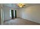 Spacious bedroom featuring soft carpet, a window with curtains, and neutral walls at 10066 Golden Bluff Ave, Las Vegas, NV 89148