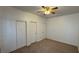 This bedroom has carpet flooring, a ceiling fan, and white painted trim and baseboards at 10066 Golden Bluff Ave, Las Vegas, NV 89148