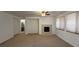 Spacious living room with neutral carpet, fireplace, and plenty of natural light at 10066 Golden Bluff Ave, Las Vegas, NV 89148