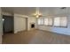 Spacious living room with a fireplace, neutral carpet, and a ceiling fan at 10066 Golden Bluff Ave, Las Vegas, NV 89148