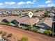 Beautiful aerial view of a single-Gathering home with a red tile roof in a desert community at 10416 Skye Arroyo Ave, Las Vegas, NV 89166