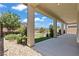 Covered patio featuring a backyard with a manicured garden and putting green at 10416 Skye Arroyo Ave, Las Vegas, NV 89166