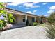 Backyard with covered patio, pavers, green plants, and a putting green at 10416 Skye Arroyo Ave, Las Vegas, NV 89166